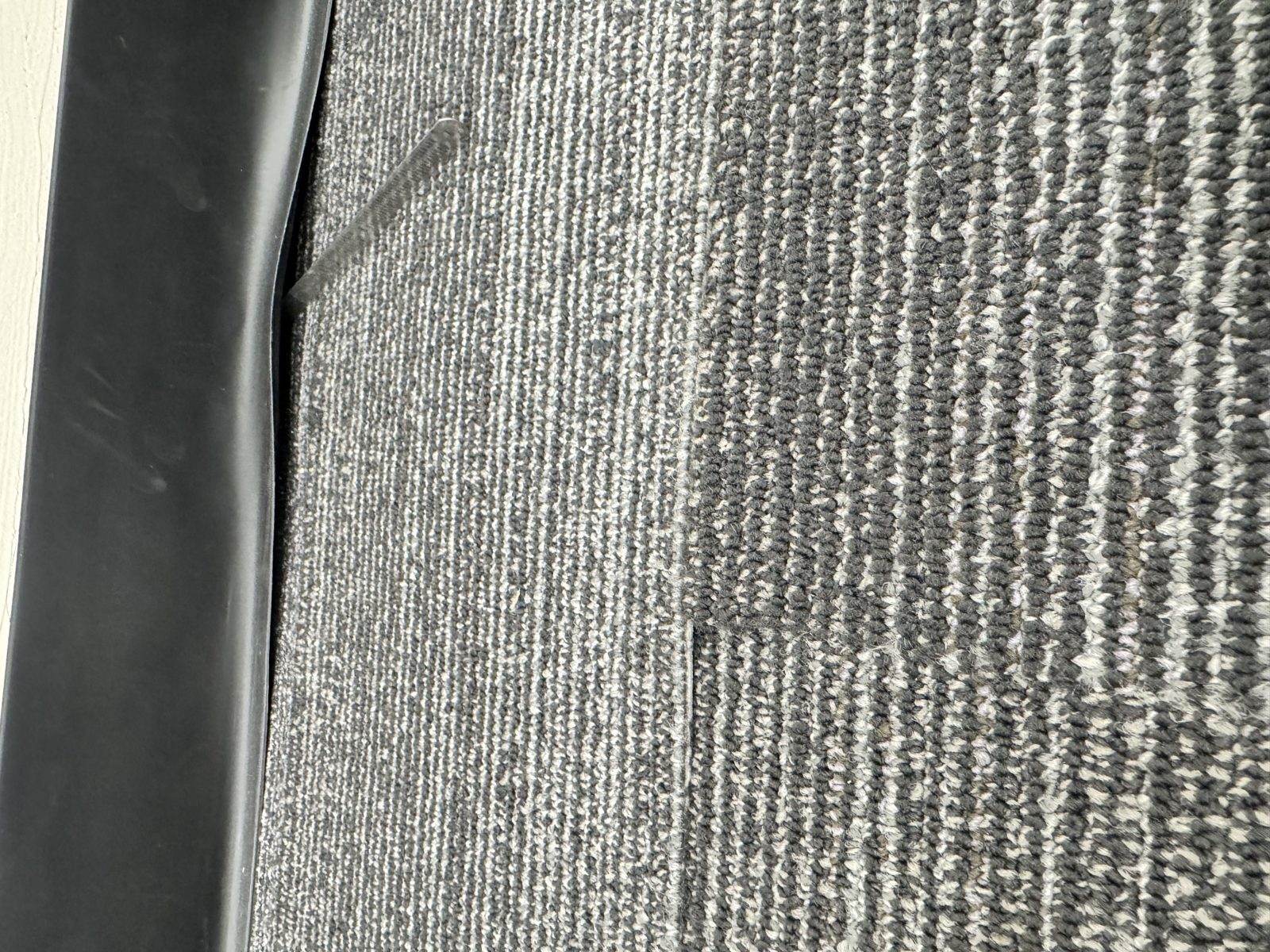 Peaking and raised edges in a carpeted hallway