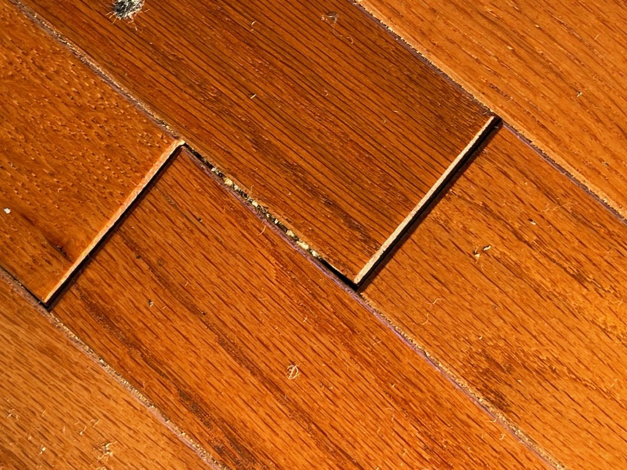 Open joint between engineered hardwood boards from improper acclimation