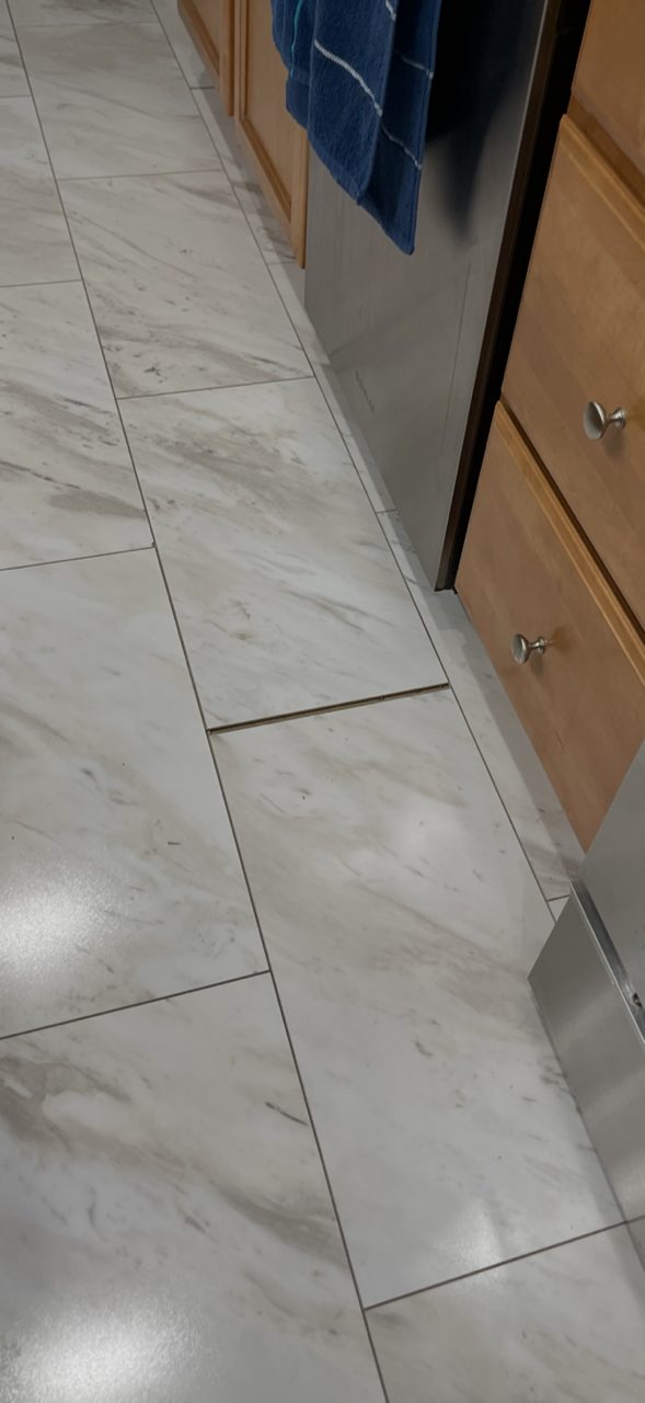 Lippage at a tile grout line in a kitchen